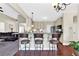 Open concept kitchen featuring stainless appliances, granite counters, eat-in bar, and hardwood floors at 95 Summerlyn Dr, Hiram, GA 30141