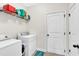 Bright laundry room featuring modern washer and dryer, wire rack, and plenty of storage space at 95 Summerlyn Dr, Hiram, GA 30141