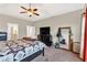 Large main bedroom with tray ceiling, ceiling fan, and en-suite bathroom access, featuring a spacious layout at 95 Summerlyn Dr, Hiram, GA 30141