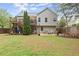 Backyard view featuring a deck, dining area, fire pit, and green lawn at 104 Puckett Creek Dr, Canton, GA 30114