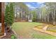 Large, grassy backyard with a shed and garden beds, perfect for outdoor activities and gardening at 104 Puckett Creek Dr, Canton, GA 30114