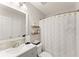Bathroom featuring a large mirror, vanity, toilet, and shower with white shower curtain at 104 Puckett Creek Dr, Canton, GA 30114