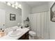 Clean bathroom with white sink, toilet, shower with tub and decorative accents at 104 Puckett Creek Dr, Canton, GA 30114