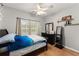 Comfortable bedroom with dark furniture, stylish decor, and a ceiling fan at 104 Puckett Creek Dr, Canton, GA 30114
