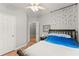 Relaxing bedroom with soft blue bedding and a ceiling fan at 104 Puckett Creek Dr, Canton, GA 30114