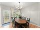 Dining room with wood table, six chairs, chandelier, and door to outdoor porch at 104 Puckett Creek Dr, Canton, GA 30114