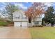 Charming split-level home featuring a two-car garage and landscaped yard at 104 Puckett Creek Dr, Canton, GA 30114