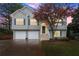 Charming split-level home featuring a two-car garage, front yard and landscaped garden at 104 Puckett Creek Dr, Canton, GA 30114