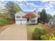 Charming split-level home featuring a two-car garage and beautifully landscaped front yard at 104 Puckett Creek Dr, Canton, GA 30114