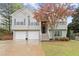 Charming split-level home featuring a two-car garage, front yard and landscaped garden at 104 Puckett Creek Dr, Canton, GA 30114
