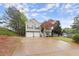 Charming split-level home featuring a two-car garage and landscaped yard at 104 Puckett Creek Dr, Canton, GA 30114