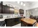 Bright kitchen featuring stainless steel appliances, dark wood cabinets, and white countertops at 104 Puckett Creek Dr, Canton, GA 30114