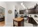 Modern kitchen with stainless steel appliances, dark wood cabinets, and center island at 104 Puckett Creek Dr, Canton, GA 30114