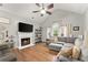 Inviting living room boasts a cozy fireplace, vaulted ceiling, and plush seating at 104 Puckett Creek Dr, Canton, GA 30114