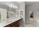 The main bathroom features a large mirror and vanity with a view of the soaking tub at 104 Puckett Creek Dr, Canton, GA 30114