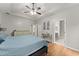 Bright main bedroom featuring a tray ceiling, ceiling fan, and a hallway leading to the bathroom at 104 Puckett Creek Dr, Canton, GA 30114