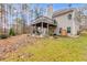 Well-manicured backyard featuring a wooden deck with stairs, a covered patio, and green lawn at 1409 Northgate Dr, Villa Rica, GA 30180
