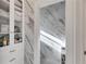 Ensuite bathroom featuring marble walls and floors and a closet at 1409 Northgate Dr, Villa Rica, GA 30180