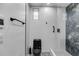 Modern bathroom with black fixtures, patterned tile flooring, a glass shower, and white subway tile at 1409 Northgate Dr, Villa Rica, GA 30180