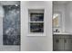 Modern bathroom with a gray vanity, white subway tile, marble-look tile shower, and built in niche at 1409 Northgate Dr, Villa Rica, GA 30180