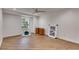 Bright bedroom with hardwood floors, ceiling fan, recessed lighting, and a large window overlooking the yard at 1409 Northgate Dr, Villa Rica, GA 30180