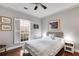 Comfortable bedroom featuring a ceiling fan, neutral paint, a queen bed, and natural light through the window at 1409 Northgate Dr, Villa Rica, GA 30180