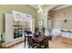 Dining room with a modern chandelier and window overlooking a wooded area at 1409 Northgate Dr, Villa Rica, GA 30180