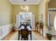 Cozy dining area featuring a modern chandelier and a large window with shutters at 1409 Northgate Dr, Villa Rica, GA 30180