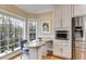Cozy breakfast nook with built-in table, stainless steel appliances and natural light at 1409 Northgate Dr, Villa Rica, GA 30180