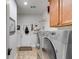 Functional laundry room featuring a washer, dryer, storage cabinets, and access to the back door at 1409 Northgate Dr, Villa Rica, GA 30180