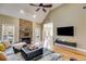 Inviting living room with a stone fireplace, hardwood floors and large windows at 1409 Northgate Dr, Villa Rica, GA 30180