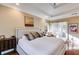 Comfortable bedroom featuring a tray ceiling, hardwood floors and a barn door to ensuite bath at 1409 Northgate Dr, Villa Rica, GA 30180