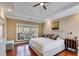 Comfortable bedroom featuring a tray ceiling, hardwood floors and a large window at 1409 Northgate Dr, Villa Rica, GA 30180