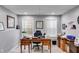 Home office featuring neutral walls, windows with blinds, and decorative wooden desk at 1409 Northgate Dr, Villa Rica, GA 30180