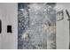 Elegant shower featuring gray marble-look tiling, a rainfall shower head, a built-in niche, and white subway tile at 1409 Northgate Dr, Villa Rica, GA 30180