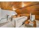 Finished attic space with wooden ceiling, cabinets, and seating area at 235 The Prado N, Atlanta, GA 30309