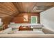 Finished attic features wood paneled ceiling, window, and sitting nook at 235 The Prado N, Atlanta, GA 30309