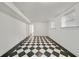 Spacious basement with black and white checkered flooring, white walls and two windows at 235 The Prado N, Atlanta, GA 30309