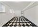 Basement with black and white checkered flooring, white walls and a glass door at 235 The Prado N, Atlanta, GA 30309
