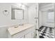 Bathroom with a white vanity, unique mirror, and black and white checkered flooring at 235 The Prado N, Atlanta, GA 30309