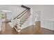 Elegant foyer showcasing a staircase with wood treads and hardwood floors at 235 The Prado N, Atlanta, GA 30309