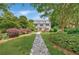 Beautifully landscaped front yard leading to a classic two-story home with dormer windows at 235 The Prado N, Atlanta, GA 30309