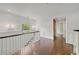 Upstairs hallway with hardwood flooring, natural lighting, and white trim details at 235 The Prado N, Atlanta, GA 30309