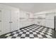 Kitchen featuring white cabinets and appliances, with unique black and white checkered flooring at 235 The Prado N, Atlanta, GA 30309