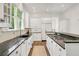 A full kitchen, with white cabinets, granite countertops, and high-end stainless appliances at 235 The Prado N, Atlanta, GA 30309