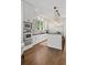 Modern kitchen with sleek white cabinetry, stainless steel appliances, and a center island at 235 The Prado N, Atlanta, GA 30309