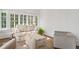 Bright living room area with floral patterned sofa set and large windows at 235 The Prado N, Atlanta, GA 30309
