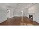 Open living space with hardwood floors and fireplace, adjacent to an entrance with a staircase at 235 The Prado N, Atlanta, GA 30309