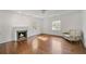 Bright living room features hardwood floors, a fireplace, and natural light from two windows at 235 The Prado N, Atlanta, GA 30309