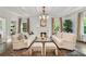 Inviting living room with beamed ceilings, fireplace, and matching sofas at 235 The Prado N, Atlanta, GA 30309